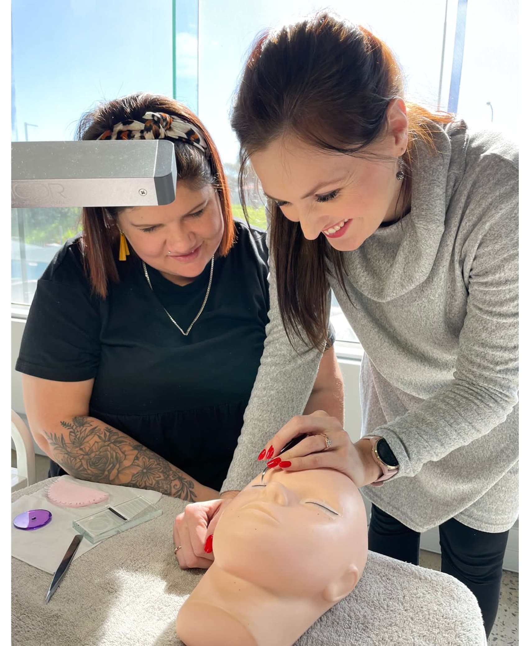 Stella Academy educator guiding a student through practical work
